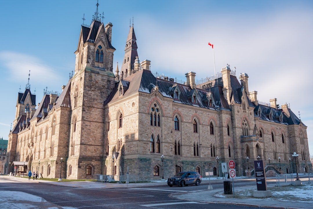 Parliament Hill in Ottawa on a winter morning with Canadian flag and gothic architecture
