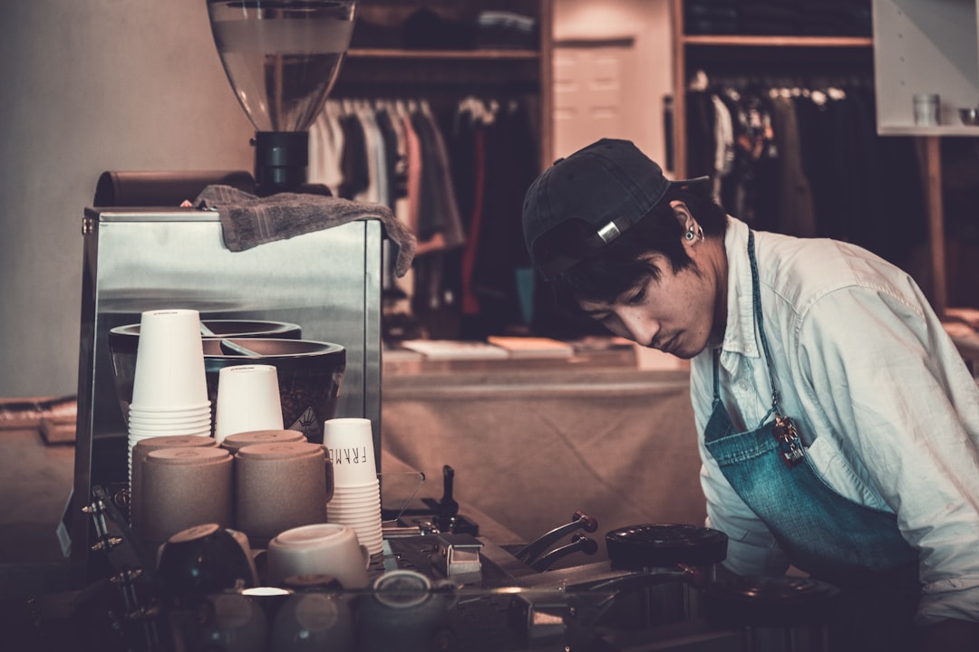 Young barista working part-time at a coffee shop, a common job for students on a study permit in Canada