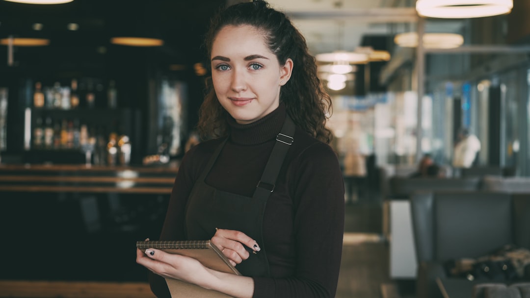 International student working a part-time job in Canada as a waitress in a restaurant