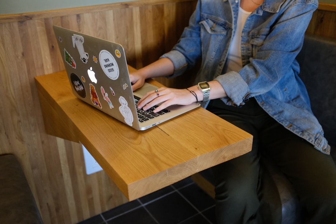 Young professional woman working on laptop, representing post-graduation work permit opportunities in Canada