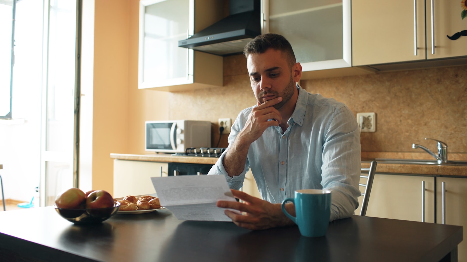 Applicant reading a Canada study permit refusal letter with a concerned expression