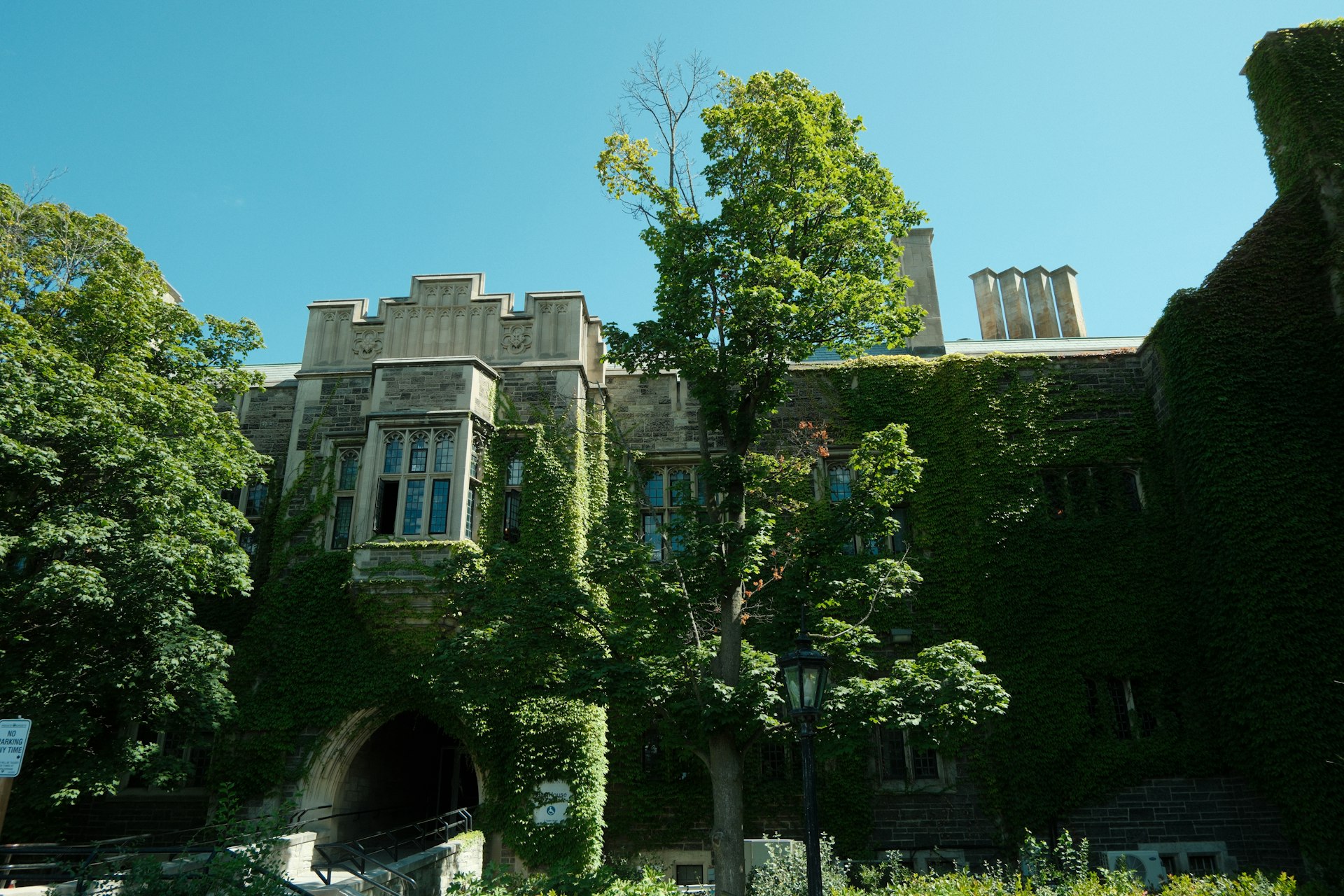 Ivy-covered Gothic stone building at the University of Toronto, a Canadian designated learning institution