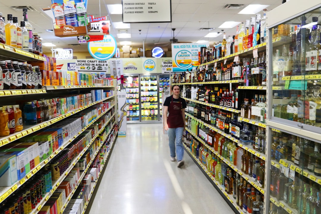 Student walking down a brightly lit grocery store aisle in Canada comparing prices