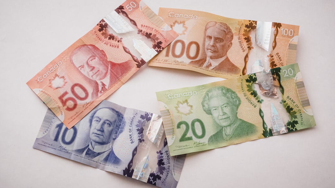 Canadian polymer bills in $10, $20, $50, and $100 denominations fanned out for budgeting